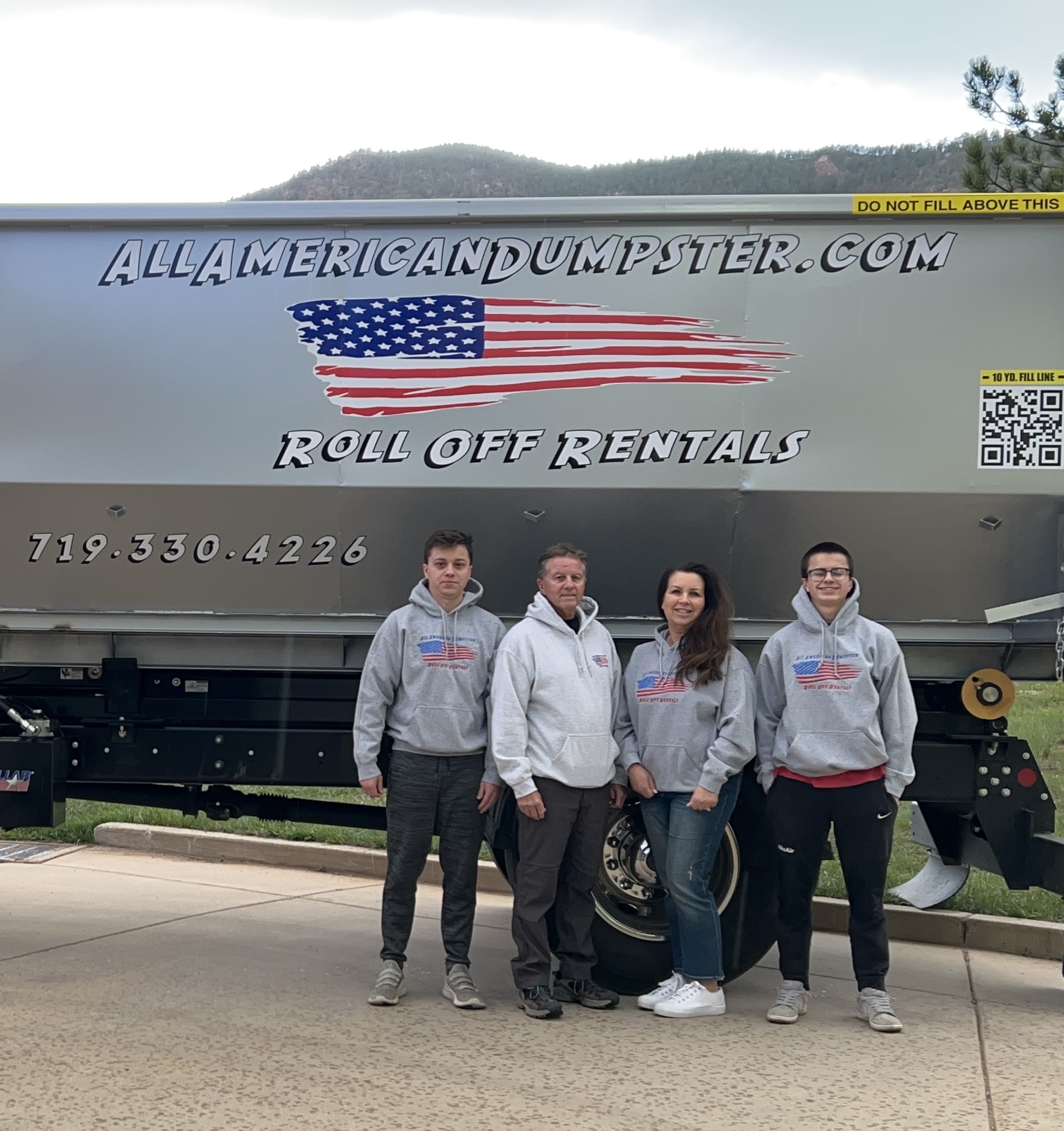 All American Dumpster team delivering a roll-off dumpster rental in Colorado Springs, CO